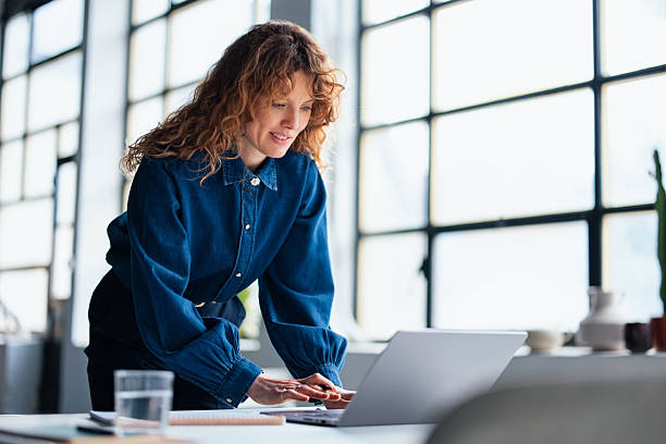 istock Young Woman Working on Laptop in a Modern Office Setting 2226298756