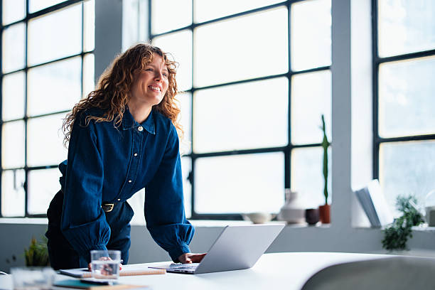 istock Confident Professional Woman Standing Near Desk in a Modern Office Setting 2226298765