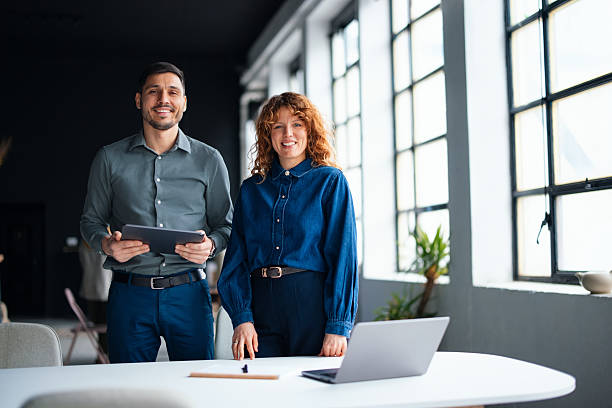 istock Smiling Colleagues Collaborating in a Bright Office Environment 2226298772