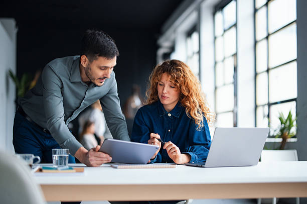 istock Professionals Discussing Project Strategy in a Modern Office Environment 2226298782