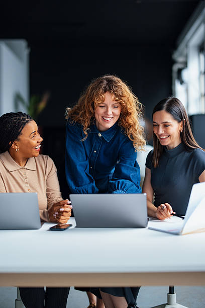 istock Three Women Collaborating on a Project in a Modern Office Setting 2226298860