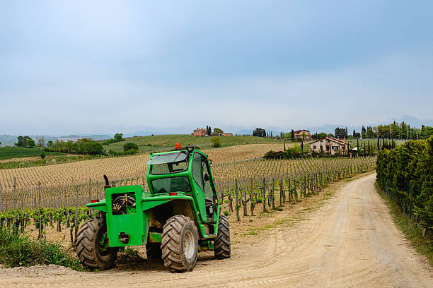 istock Tractor in vineyard with rolling hills and farmhouse 2226300466