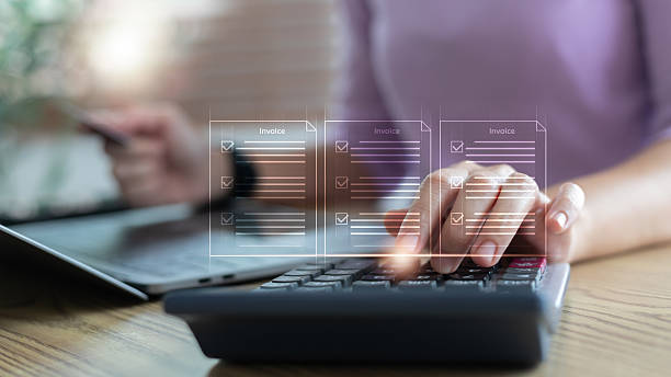 istock Close-up of a hand using a calculator with floating invoice icons, showing digital billing, online invoice management, accounting tasks, and finance operations. 2226305540
