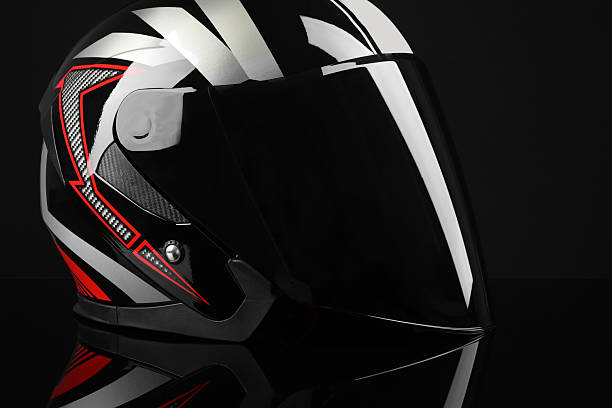 Motorcycle helmet with visor on black background, closeup