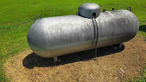 istock Large industrial propane tank installed outdoors on grass, designed for fuel storage and efficiency. The tank showcases durability and purpose for various industries and homes 2226305755