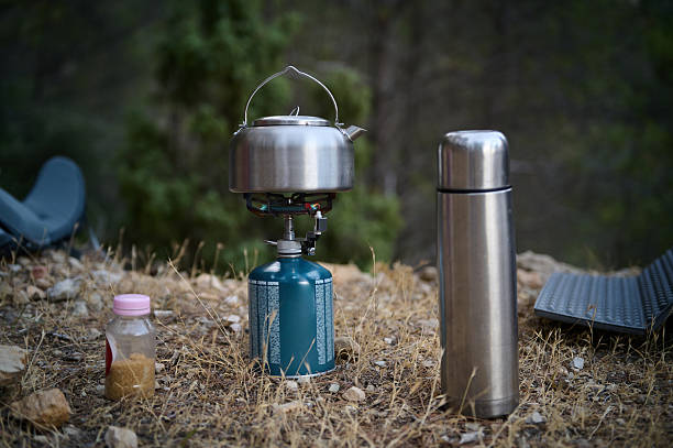 istock Outdoor Camping Stove and Gear with Scenic Forest Backdrop 2226306949