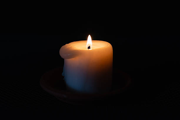 istock A burning candle in the darkness. Selective focus,black background. 2226307192