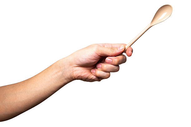 woman hand holding wooden spoon isolated on white background, space for text