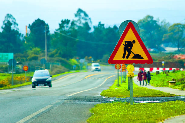 Road works ahead,  road signs, cars. Country road,  Galicia, Spain.