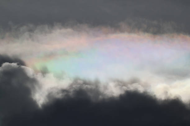 In the sky behind the clouds a soft Irization in the sky in the late afternoon