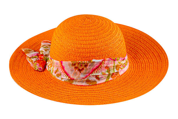 Orange colored straw hat with colorful ribbon flat lay, cutout, clipping path, isolated on white, studio shot
