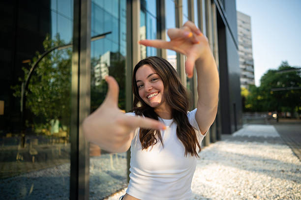 istock Young woman framing a shot with her hands and smiling 2226321899
