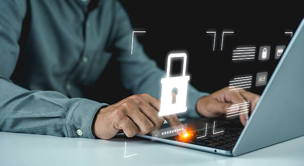 istock A person types on a laptop with a glowing digital padlock overlay, symbolizing cybersecurity and data protection. 2226323077