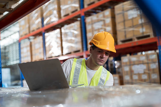 istock Warehouse and male worker working with laptop computer for inspection, inventory and checking stock, distribution, logistics in warehouse 2226323123