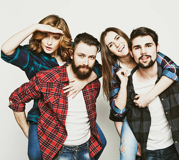 emotional, happiness and people concept: Group Of Young People Giving Piggybacks over white background.Special Fashionable toning photos.