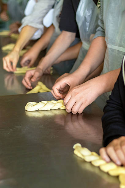 istock Children learn to make pastries from raw dough. Culinary master class on making buns 2226328584