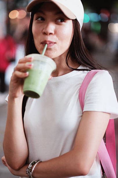 istock Green Energy: Stylish Young Woman Chats Over Iced Matcha Latte 2226328775
