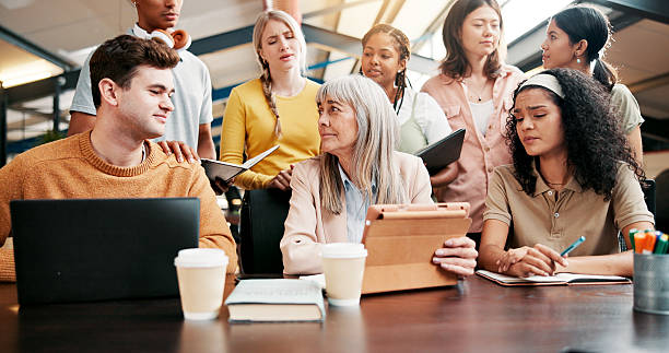 istock Education, students and lecturer with tablet, group and sad for last lesson in classroom and thinking. Knowledge, communication and mature woman with tech for assignment, people and end of semester 2226329231
