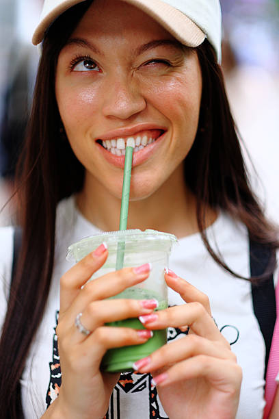 istock Green Energy: Stylish Young Woman Chats Over Iced Matcha Latte 2226329536