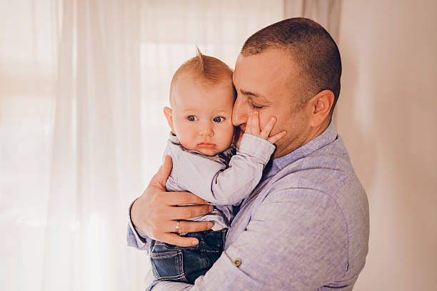 Father holding his baby son. Man enjoy with baby.