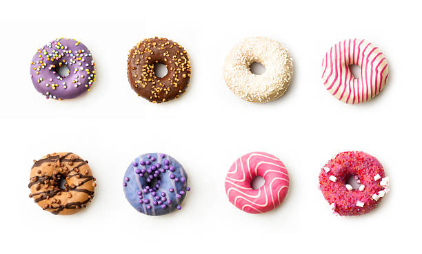 istock Colorful assortment of donuts with various toppings arranged in two rows on a white background 2226329657