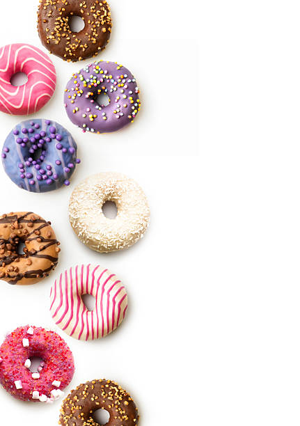 Colorful assortment of donuts displayed on a white background, showcasing various toppings and flavors for a delightful treat