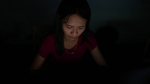 istock Woman focused on her work in dimly lit environment, showcasing concentration and determination. soft light highlights her features, creating serene atmosphere 2226330667