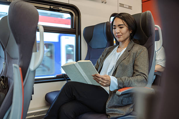 istock Professional woman reading a book while traveling on a train 2226331461