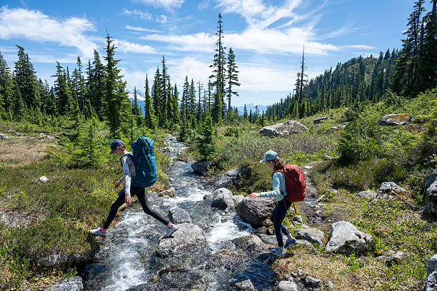 istock Young girls cross mountain stream 2226334225