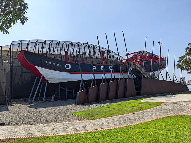 Tainan, Taiwan - December 01 2022: A traditional Chinese junk ship, featuring striking red, black, and white colors, stands proudly on display at Anping Harbor, showcasing Taiwan's maritime heritage