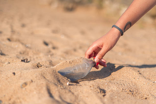 istock Volunteer collecting plastic bottle on the beach 2226336984