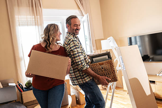 A married couple is moving into their new apartment.