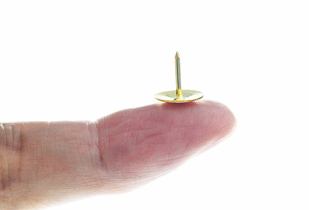 istock Close-up of hand holding a pushpin 2226337728