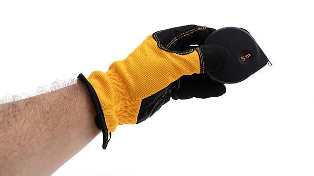 istock Measuring tape held by a gloved hand in workshop 2226338867