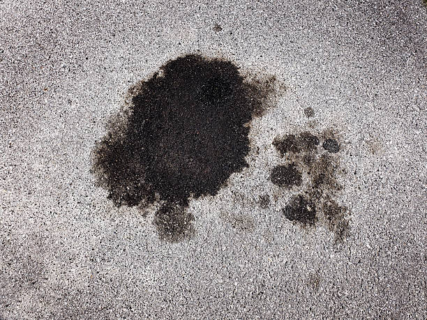 Oil spill spilled from car on roadway parking area