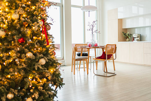 istock Classical Christmas decorated interior kitchen. Modern classic style interior design apartment dining room and Christmas tree with red golden ornament decorations. Christmas eve at home. 2226346038