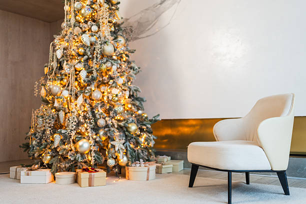 istock Classical Christmas decorated interior living room. Modern classic style interior design apartment with cozy chair and Christmas tree with white golden ornament decorations. Christmas eve at home. 2226346047