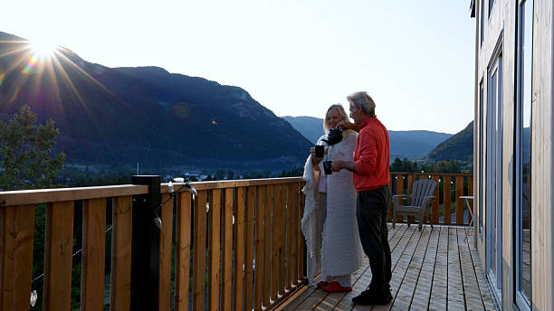 istock Mature couple enjoy tea on cabin deck at sunrise 2226347353