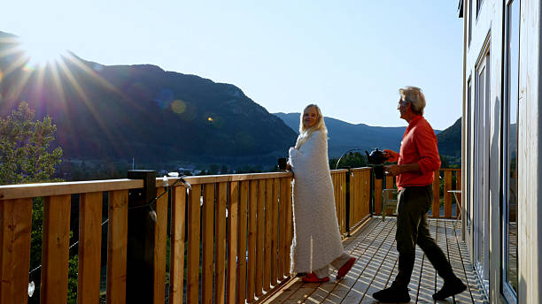 istock Mature couple enjoy tea on cabin deck at sunrise 2226347355