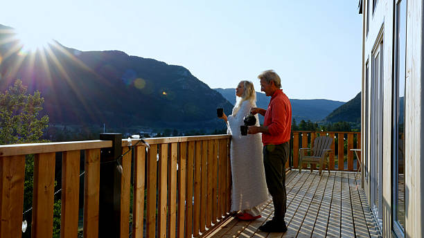 istock Mature couple enjoy tea on cabin deck at sunrise 2226347362