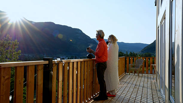 istock Mature couple enjoy tea on cabin deck at sunrise 2226347368