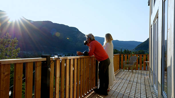 istock Mature couple enjoy hot tea on cabin deck at sunrise 2226347376