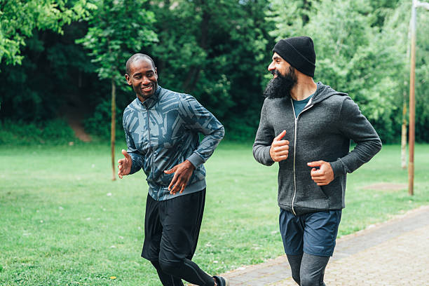 istock Cardio training outdoors. Happy athletes having fun while running together in nature. 2226350647