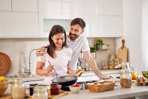 istock Happy couple cooking together in modern kitchen 2226351958