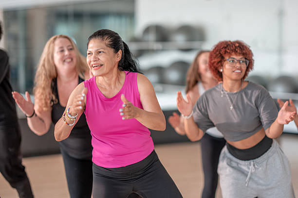 istock Group Fitness Class with Smiling Participants in a Modern Gym Setting 2226352729