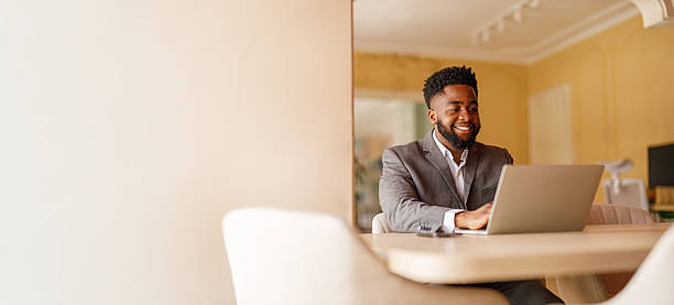 istock Male financial advisor examining reports over laptop while working at desk by wall in modern office 2226353037