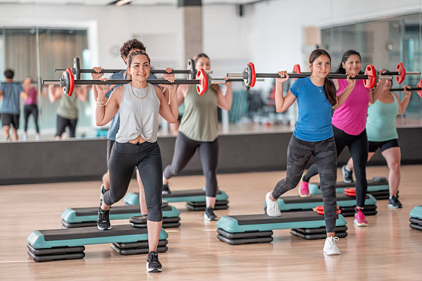 Group of Women Performing Fitness Exercises in a Gym Setting stock photo