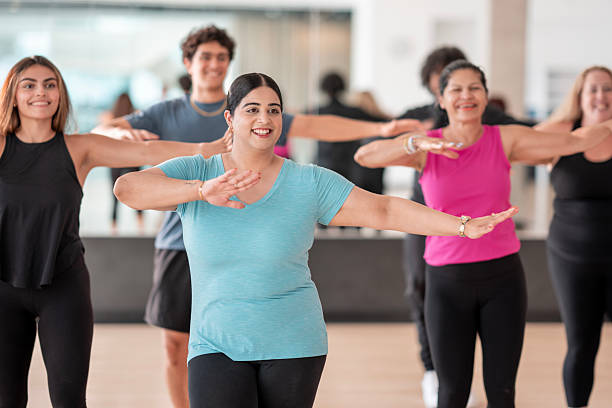 istock Group Fitness Class With Smiling Participants Engaged in an Aerobic Exercise Session 2226354385