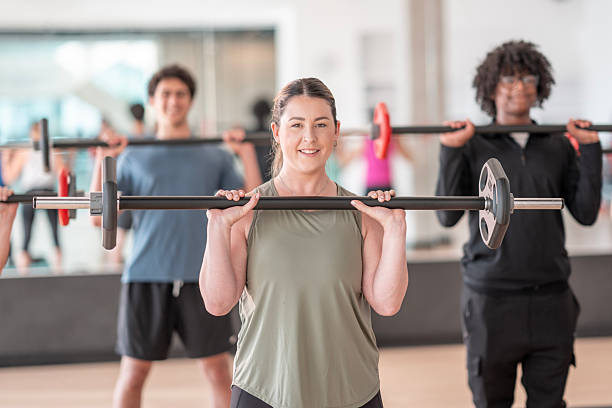 istock Group Fitness Class Lifting Weights in a Gym Setting 2226355659