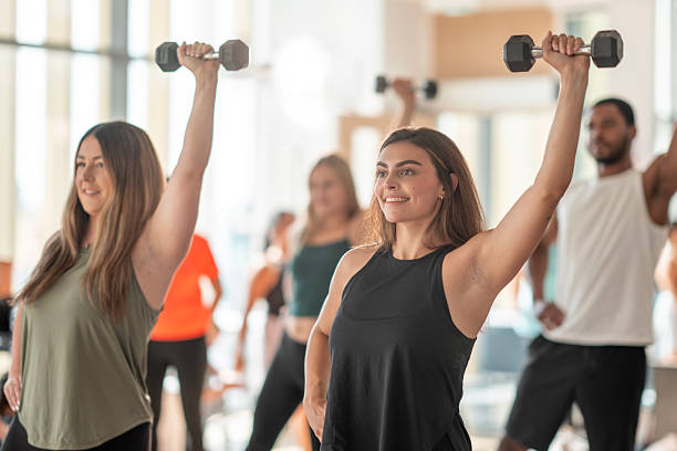 Group Fitness Class with Dumbbells in a Bright Studio Setting
